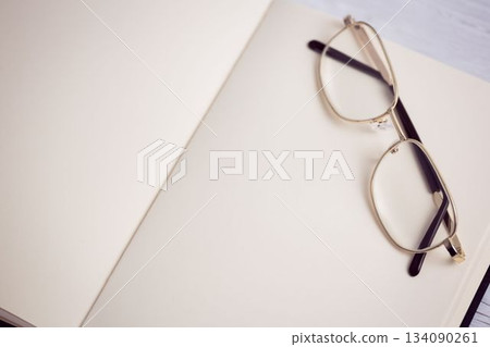 Metallic eyeglasses on wooden table 134090261