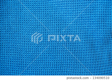 Blue knitted fabric texture with waffle pattern Blue knitted fabric texture with waffle pattern 134090510