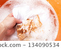 Soaking stained white clothes in detergent for laundry and hygiene 134090534