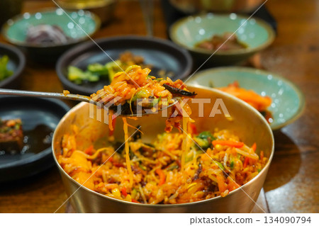 Delicious Jeonju style Bibimbap Mixed in a Traditional Korean Brass Bowl Delicious Jeonju style Bibimbap Mixed in a Traditional Korean Brass Bowl 134090794