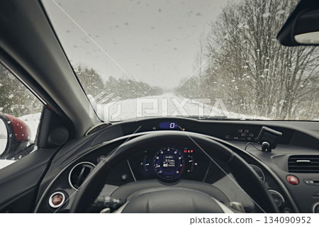 View of a snowy winter road from the window of a Honda Civic car View of a snowy winter road from the window of a Honda Civic car 134090952