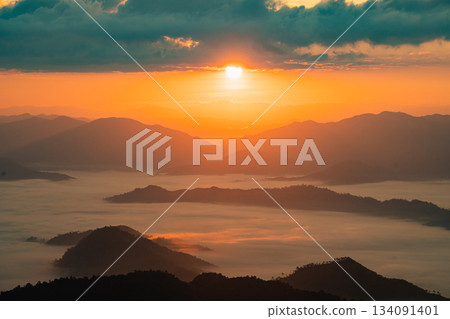 Breathtaking Sunrise Over Misty Mountains and Valleys, Showcasing a Tranquil Landscape of Nature's Beauty at Dawn with Vibrant Colors and Soft Clouds 134091401