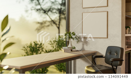 Books and vase on a wooden table with a leather armchair in a glass wall room with scenery outside. 134091449