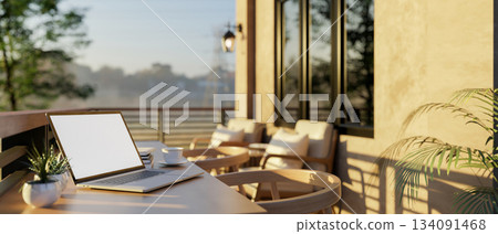 White screen laptop on wooden counter with armchairs at the sunlight terrace of a cafe or restaurant White screen laptop on wooden counter with armchairs at the sunlight terrace of a cafe or restaurant 134091468