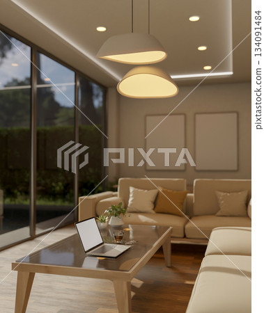 Laptop and coffee on glass top wooden table next to white sofa under warm lamp light in living room. Laptop and coffee on glass top wooden table next to white sofa under warm lamp light in living room. 134091484