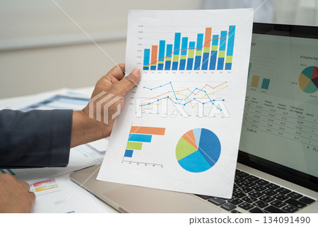 Asian business woman working with financial graph. 134091490