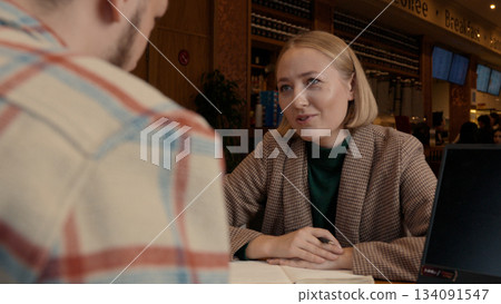 Male client signing a contract, focused on the document during consultation Male client signing a contract, focused on the document during consultation 134091547