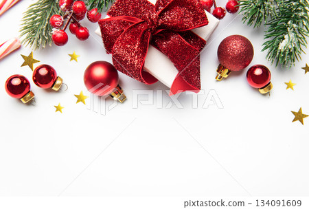 Christmas gift with red ornaments and pine branches Christmas gift with red ornaments and pine branches 134091609