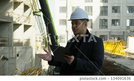 Engineer and foreman discussing blueprints on a construction site Engineer and foreman discussing blueprints on a construction site 134091636