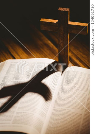 Wooden cross with shadow on bible 134091750