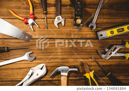hand tools are being shown in flat design on wooden workbench with hammer, pliers, copy space hand tools are being shown in flat design on wooden workbench with hammer, pliers, copy space 134091804