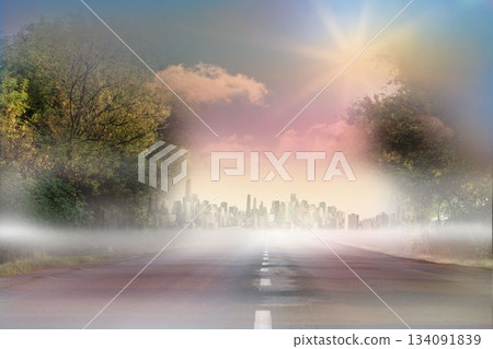 Sunny road leading to city 134091839