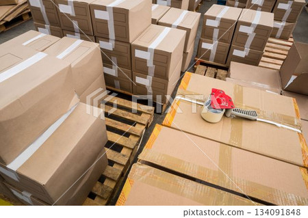 Tape dispenser on cardboard boxes 134091848