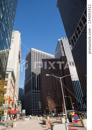 Flat design illustration is depicting busy urban plaza with red metal chairs and high-rise facades Flat design illustration is depicting busy urban plaza with red metal chairs and high-rise facades 134091911