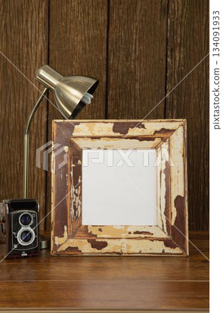Photo frame, camera and table lamp on table Photo frame, camera and table lamp on table 134091933