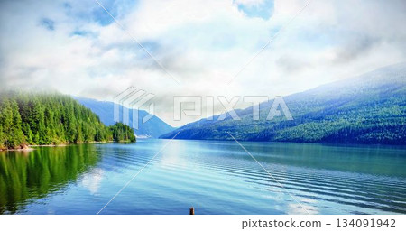 River amidst mountains against cloudy sky River amidst mountains against cloudy sky 134091942