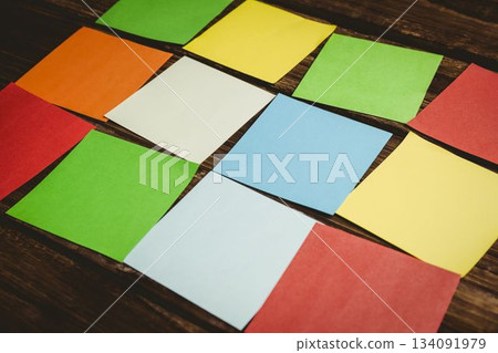 multi colored papers on wooden flooring multi colored papers on wooden flooring 134091979