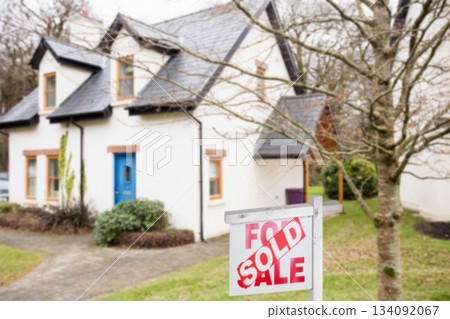 Real estate signboard by tree 134092067
