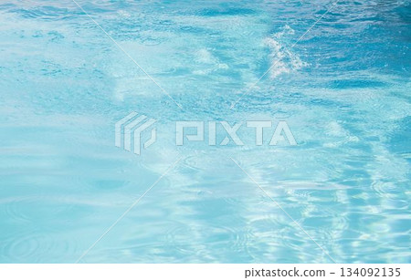 Flat design water surface is shimmering under bright sunlight with subtle ripples and reflections 134092135