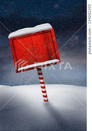 Red wooden signboard candy-striped pole are standing amid falling snow on snowdrifts under dark sky Red wooden signboard candy-striped pole are standing amid falling snow on snowdrifts under dark sky 134092203