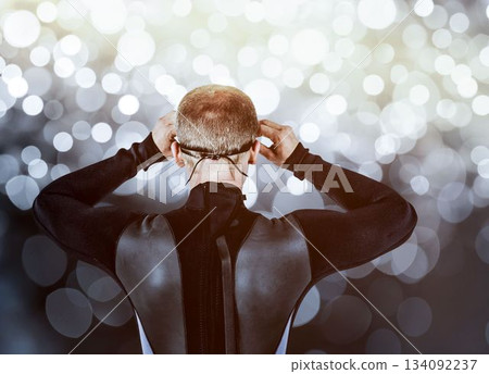 Rear view of swimmer against digitally generated lens flare 134092237