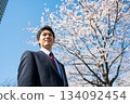 AI-generated image of a man in a suit and cherry blossoms 134092454