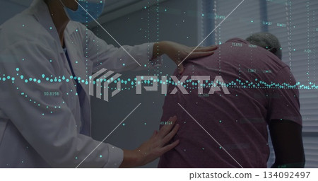 Examining patient's back, healthcare professional using data image for analysis 134092497