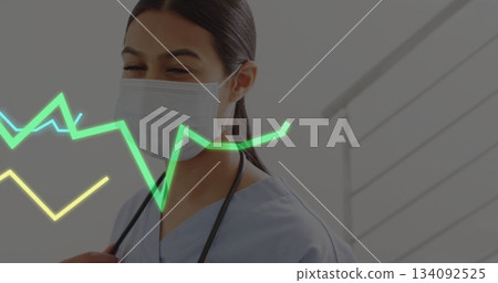 Wearing mask, healthcare worker with image of heartbeat line in background 134092525