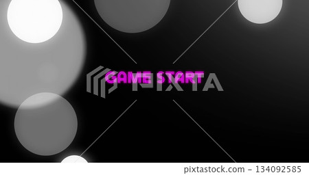 Displaying neon pink GAME START text glowing on digital display, featuring gray bokeh circles 134092585