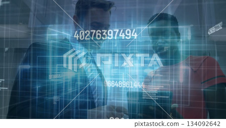 Smiling man in suit viewing smartphone with colleague in red top in lobby, with holographic codes Smiling man in suit viewing smartphone with colleague in red top in lobby, with holographic codes 134092642