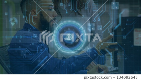 Collaborating developer and UX designer reviewing monitor in tech office with circuit overlay Collaborating developer and UX designer reviewing monitor in tech office with circuit overlay 134092643