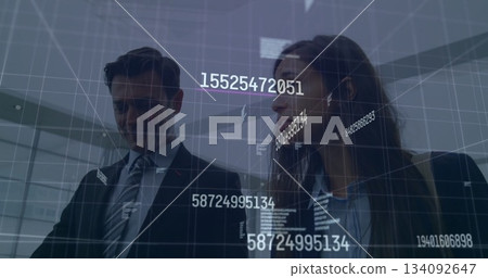 Discussing data, business professionals with digital numbers overlaying scene 134092647