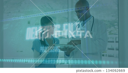Doctor pointing at screen with nurse in scrubs holding tablet in hospital corridor, digital overlay Doctor pointing at screen with nurse in scrubs holding tablet in hospital corridor, digital overlay 134092669