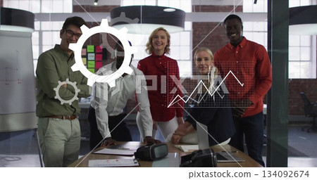 Collaborating team of five discussing plan around table in office, with laptop, VR headset Collaborating team of five discussing plan around table in office, with laptop, VR headset 134092674