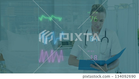 Holding clipboard nurse wearing scrubs and stethoscope reviewing vital waveforms in patient room Holding clipboard nurse wearing scrubs and stethoscope reviewing vital waveforms in patient room 134092690