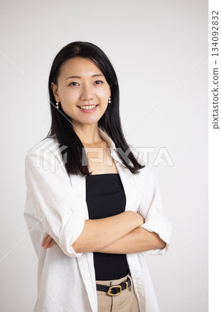 Smiling woman with arms folded Smiling woman with arms folded 134092832