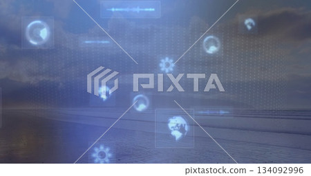 Floating digital interface elements over shoreline, showing rotating globe, gear and waveform icons 134092996