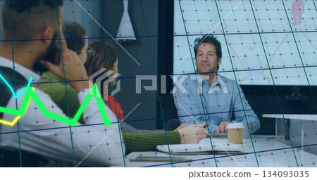 Leading discussion mid adult man in blue shirt at conference table, with data overlay, copy space Leading discussion mid adult man in blue shirt at conference table, with data overlay, copy space 134093035