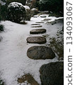 Snow garden New Year's card material - A winter early morning stroll along the stepping stones of a strolling Japanese garden covered in the first snow 134093067
