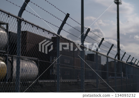 A scene of a factory with a barbed wire fence 134093232