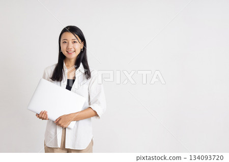 Smiling woman holding a laptop Smiling woman holding a laptop 134093720