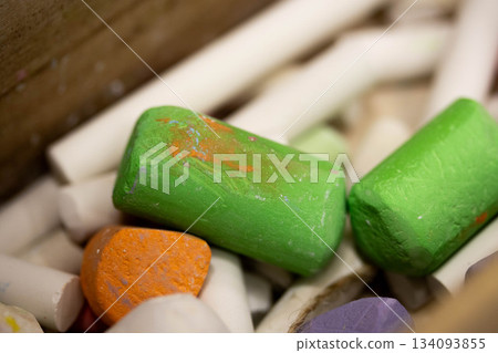 Colorful chalk pieces in a classroom box Colorful chalk pieces in a classroom box 134093855