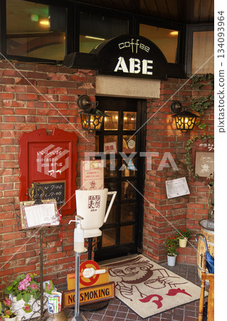The entrance and sign of a retro coffee shop with an impressive brick wall in Matsumoto City 134093964