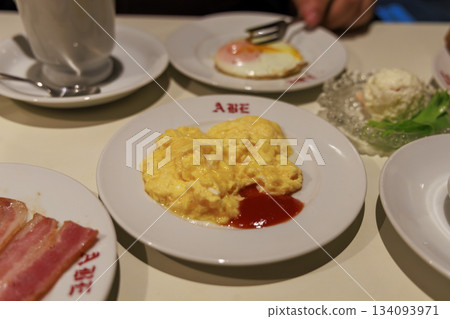 A plate of scrambled eggs and fried eggs for breakfast at a coffee shop A plate of scrambled eggs and fried eggs for breakfast at a coffee shop 134093971