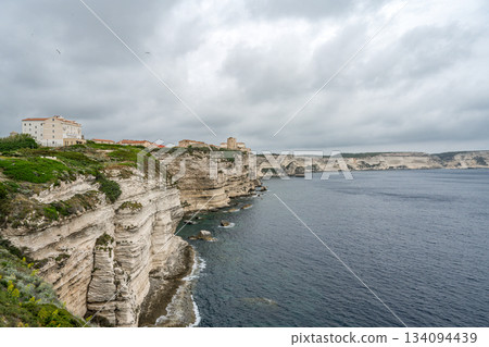 Aerial view marina cape Bonifacio south Corsica France citadel on rocky promontory on wild white limestone cliffs 134094439