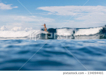 Surfer on surfboard during surfing. Surfer woman and ocean wave Surfer on surfboard during surfing. Surfer woman and ocean wave 134094481