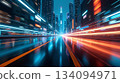 A dynamic futuristic city scene featuring vibrant neon lights, reflective surfaces, and dramatic motion blur that creates a sense of high-speed movement through a modern sci-fi urban environment. 134094971