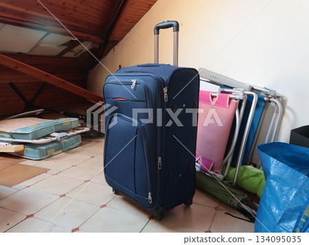 Suitcase, old things in attic. Objects of house. Cleanliness and tidiness of the house. Suitcase, old things in attic. Objects of house. Cleanliness and tidiness of the house. 134095035