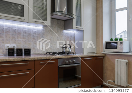 Modern Kitchen Interior with Gas Stove, Oven and Microwave 134095377