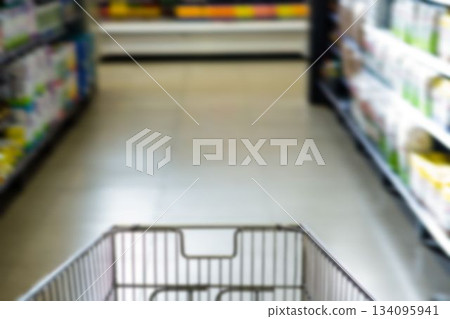 Shopping cart on aisle at supermarket 134095941